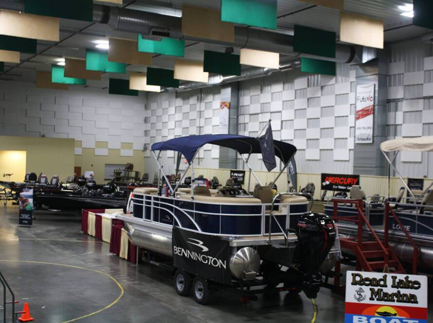 Boat show inside The Pavilion in Marion, Illinois, featuring Bennington pontoon boats and vendor displays