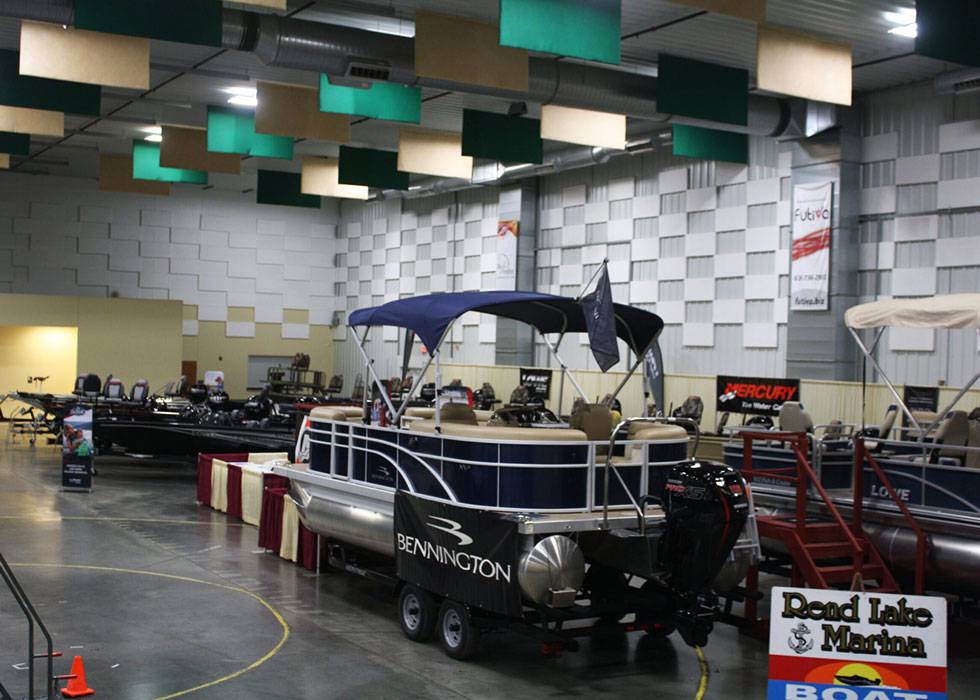 Boat show inside The Pavilion in Marion, Illinois, featuring Bennington pontoon boats and vendor displays