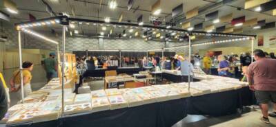 The Pavilion Expo Hall during a vendor event with booths, display tables, and attendees browsing exhibits under bright lighting